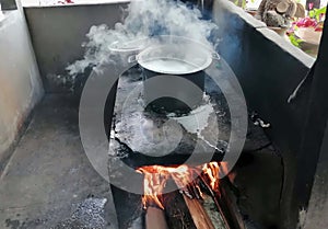 A vintage classics cooking pot on the fire in the kitchen of a restaurant