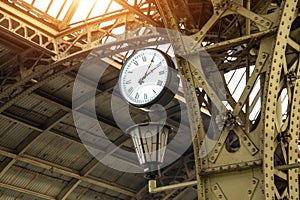 Vintage clock and lantern on train station with building roof