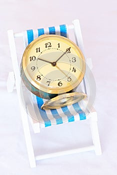 Vintage clock on a lawn chair