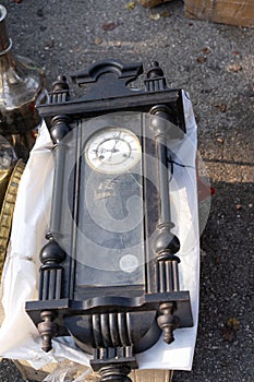 Vintage clock with a pendulum at the fair