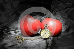 Vintage clock and red heart on black background ,Love and time concept in still life photography.