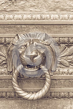 Close-up door handle lion with ring in mouth, classic knocker