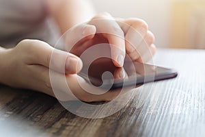 Vintage close up of woman hands holding smartphone, touching a mobile phone screen. Online communication concept