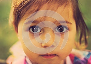 Vintage closeup portrait of Cute sad kid with big eyes