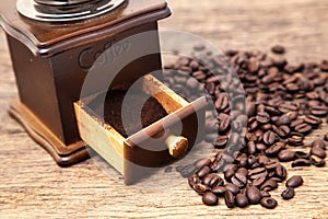 Vintage coffee bean grinder and fresh ground coffee