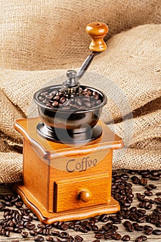 Vintage Coffee Grinder isolated on a wooden table, copy space