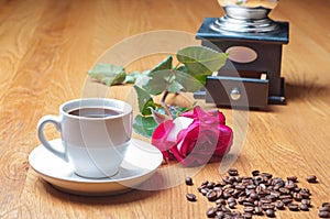 Vintage coffee mill, cup and rose