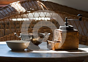 Vintage coffee mill on wooden table and sunlight