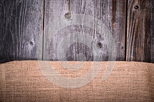 Vintage coffee sack against wooden background