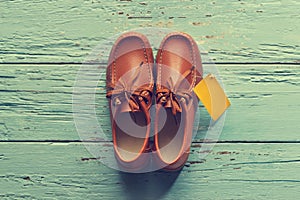 Vintage color style, Male shoes with tag on wooden background