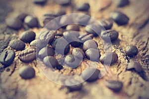 Vintage color tone, coffee beans on the old wooden background