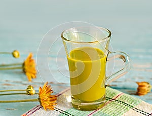 Vintage color tone style of green tea latte on fabric and blue wooden background