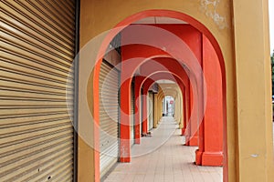 Vintage colourful arches of a sidewalk alley lined with closed shops in the world