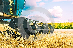 Vintage combine harvester working on oat field in summer photo