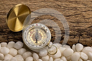 Vintage compass, navigational compass on wooden background