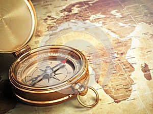 Vintage compass on the old world map. Travel concept.