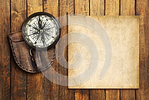 Vintage compass on the wooden background with the blank for your text