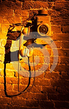 Vintage Connection: Old Telephone Gracing a Brick Wall