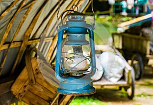 Vintage converted oil lamp hanging from camping hut