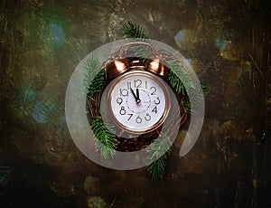 Vintage Copper Alarm Clock Five Minutes to Midnight New Years Countdown Christmas Wreath Fir Tree Branches on Black Background Gli