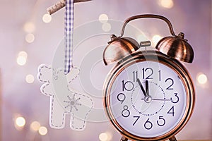 Vintage Copper Alarm Clock Showing Five Minutes to Midnight. New Year Countdown. Wood Christmas Tree Deer Ornament Hanging