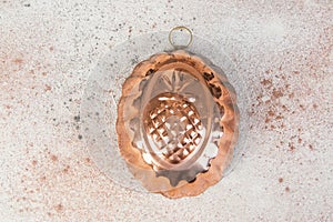 Vintage copper mold on a concrete background