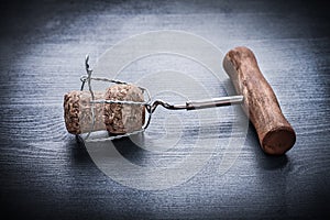 Vintage corckscrew in cork of champagne