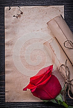 Vintage corded paper rolls red rose on wooden