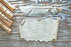 Vintage corded paper scrolls parchment plume on wooden board