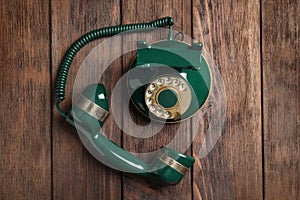 Vintage corded phone on wooden table