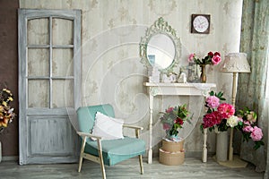 Vintage country house interior with mirror and a table with a va