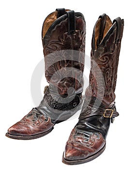 Vintage cowboy boots with spurs isolated on white background