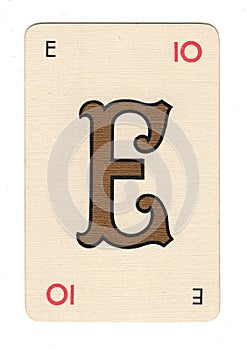 Vintage cream playing card showing the letter E in gold.