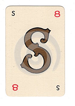 Vintage cream playing card showing the letter S in gold.