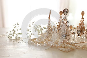 Vintage crown and pearls necklace. Wedding concept. Back light