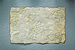 Vintage crumpled sheet of paper on grey background top view