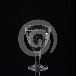 vintage crystal shot glass of vodka on black background