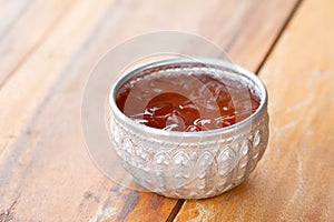 A vintage cup of iced tea on wooden table, summer drink