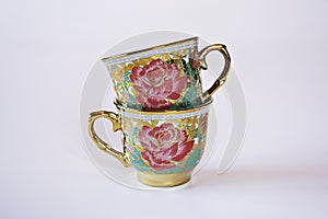 Vintage cup of tea with saucer isolated on white background ,Antique tea cup with golden rose pattern English style