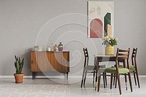 Vintage cupboard in grey elegant living room interior, copy space on empty wall