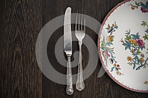 Vintage cutlery and crockery on wooden table