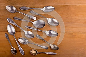 Vintage cutlery. different spoons on wooden background. Antique silverware. Retro