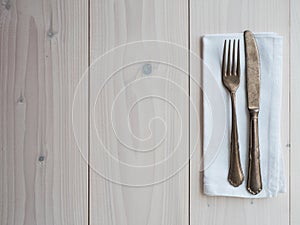 Vintage cutlery and napkin on wooden board. table set