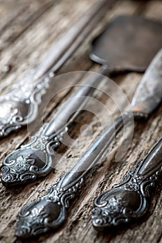 Vintage cutlery on rustic wooden background