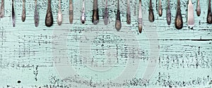 Vintage cutlery - spoons, forks and knives on an old wooden background