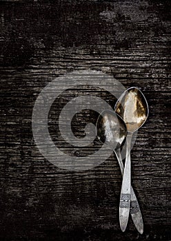 Vintage cutlery - spoons, forks and knives on an old wooden background