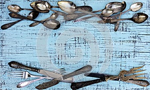 Vintage cutlery - spoons, forks and knives on an old wooden background