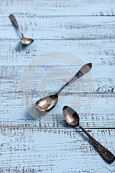 Vintage cutlery - spoons, forks and knives on an old wooden background