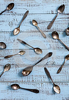 Vintage cutlery - spoons, forks and knives on an old wooden background