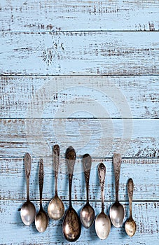 Vintage cutlery - spoons, forks and knives on an old wooden background